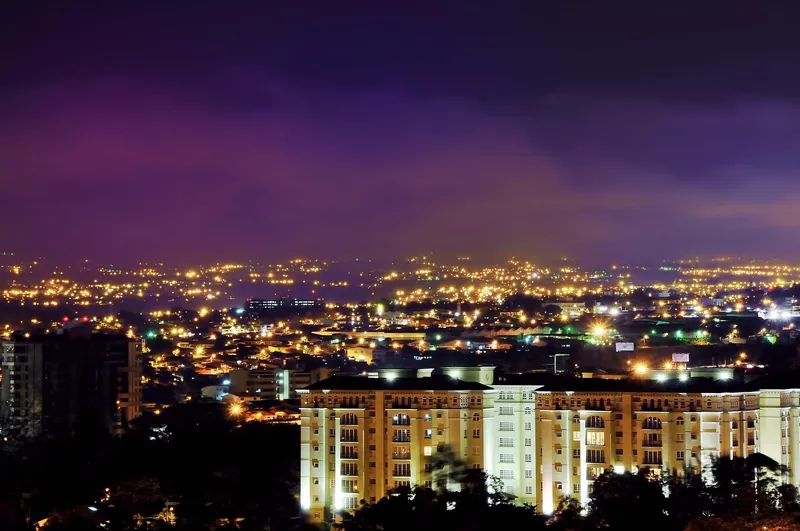 Residential towers and lights of Escazú at night, with the Central Valley behind