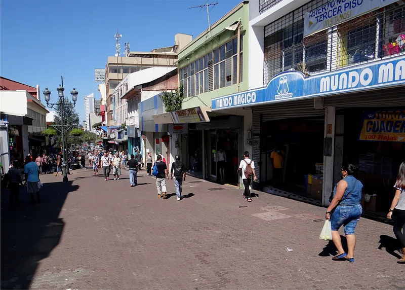 Pedestrian zone on Avenida Central in central San José with shops and passers-by