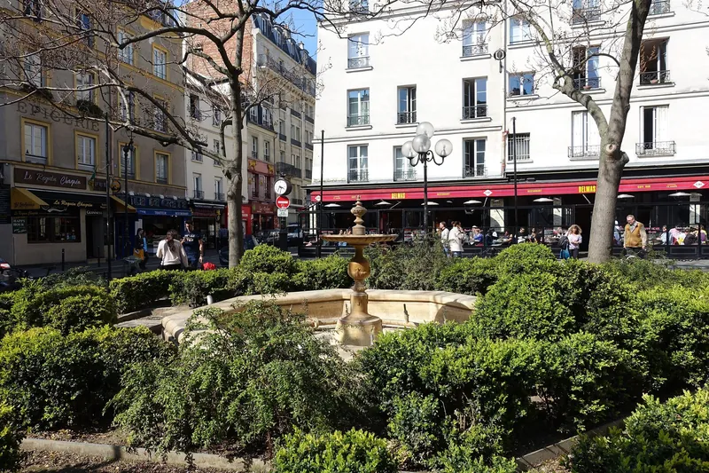 Place de la Contrescarpe at the top of Rue Mouffetard in Paris's 5th arrondissement, with a fountain and café terraces