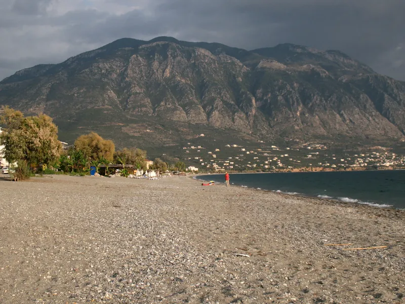 Kalamata's pebble beach on the Messinian Gulf with the Taygetos mountains behind
