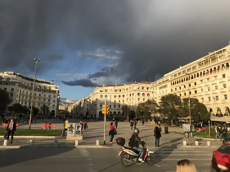 Aristotelous Square in Thessaloniki with passers-by and the arcaded buildings around it