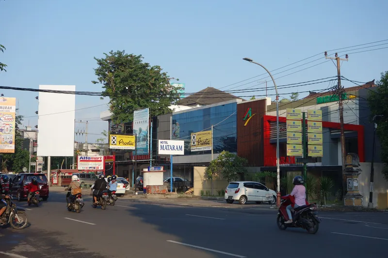 Main street with shops and scooter traffic in Mataram, Lombok's capital
