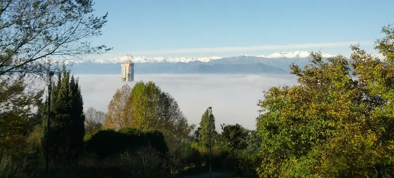 The Piedmont Region skyscraper rising above fog over Turin, seen from Parco Europa. From November to February the Po Valley often has temperature inversions with heavy air pollution.