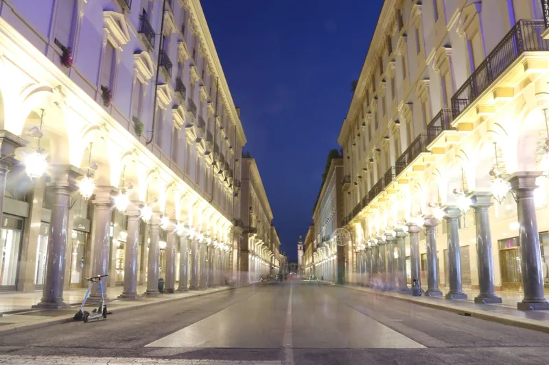 Lit arcades of Via Roma in Turin in the evening