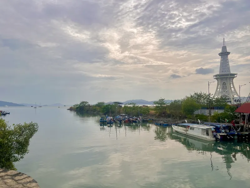 Fishing boats on the Kuah waterfront with the Maha Tower viewpoint, Langkawi