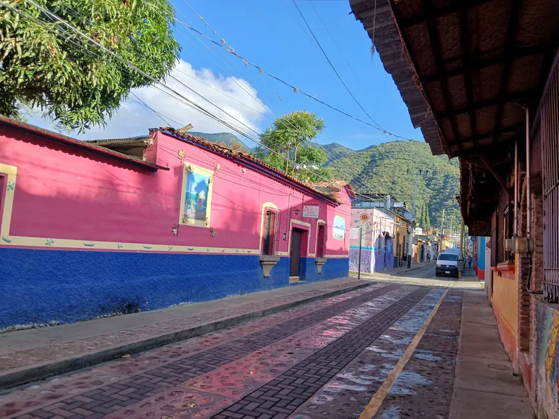 Calle Colón in central Ajijic with painted houses and the sierra behind