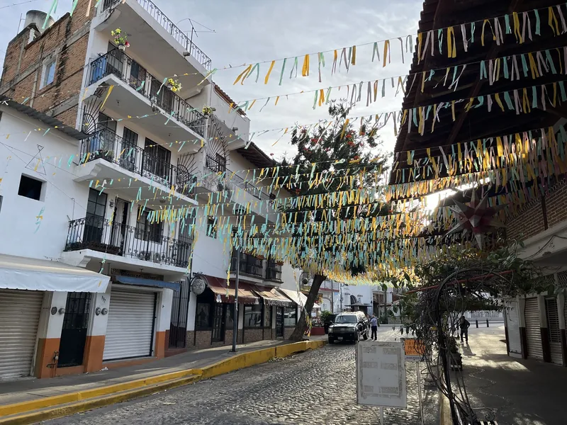 Lane in Puerto Vallarta's Zona Romántica strung with colourful paper banners