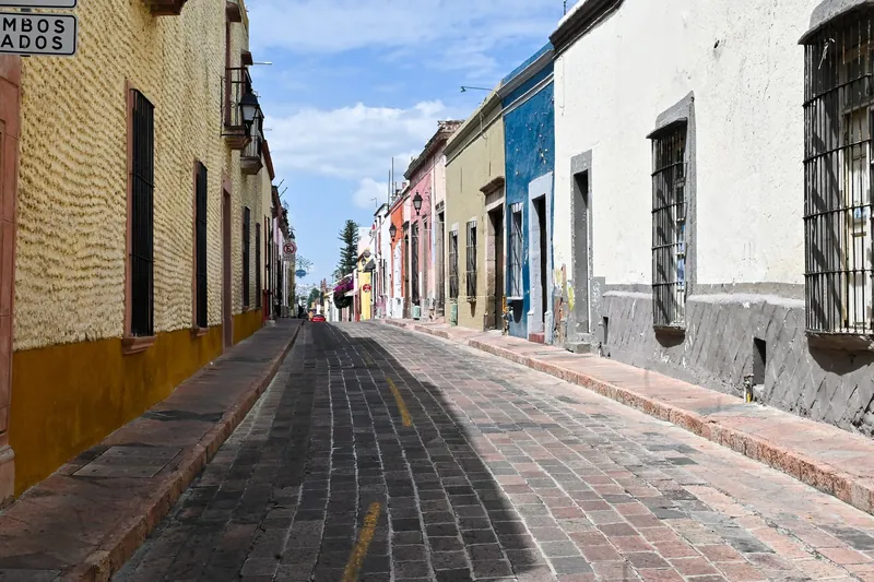 Cobbled street with painted colonial houses in Querétaro's historic centre