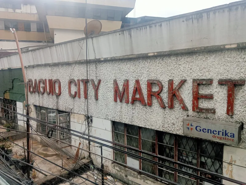 Verwitterter Schriftzug und Gebäude des Baguio City Market