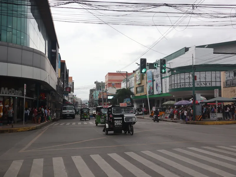 CPG Avenue at Ingles Street in central Tagbilaran City, Bohol, with tricycles