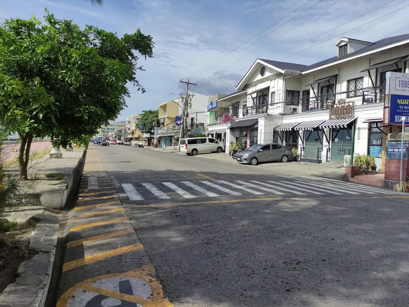Quiet shopping street with two-storey homes and shops in Dumaguete City