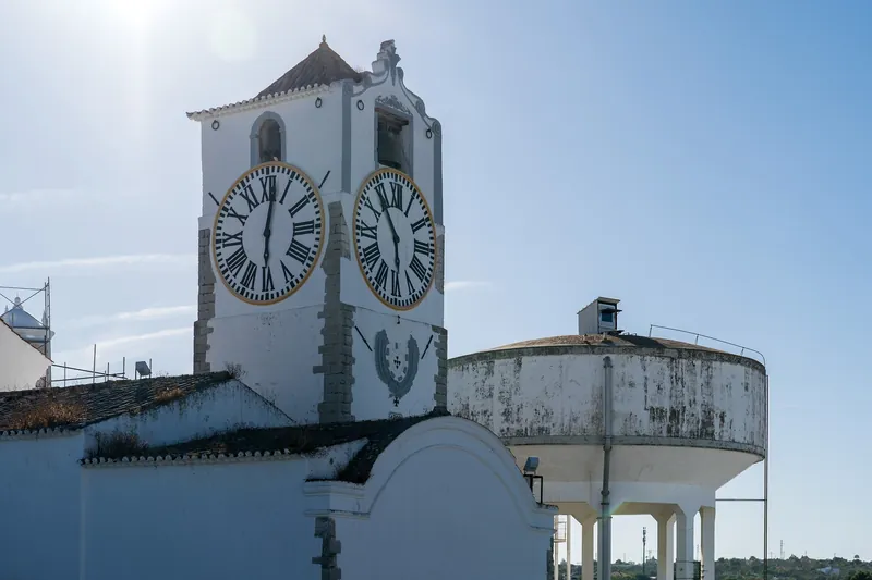 Glockenturm der Igreja de Santa Maria do Castelo in Tavira mit zwei Zifferblättern