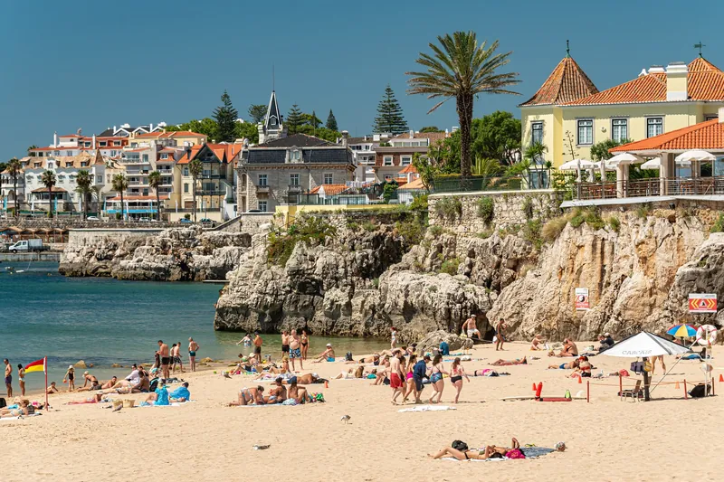 Swimmers and sunbathers at Praia da Rainha in Cascais