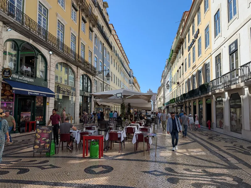 Café and restaurant tables on the pedestrianised Rua Augusta in Lisbon's Baixa