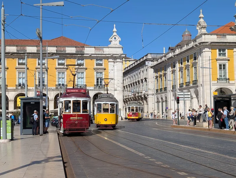 Drei Straßenbahnen der Baureihe Remodelados an der Praça do Comércio in Lissabon