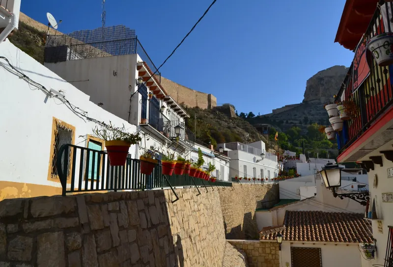 Lane with flowerpots in Alicante's Barrio de Santa Cruz below Santa Bárbara Castle