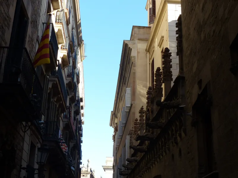 Narrow lane in Barcelona's Gothic Quarter (Barri Gòtic) with a Catalan flag on a balcony