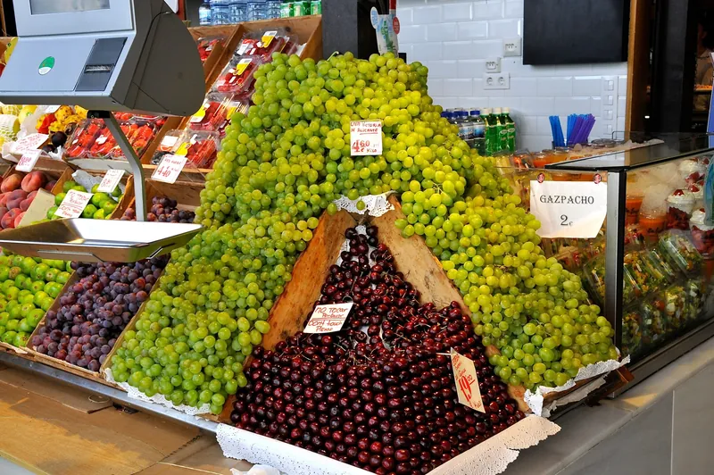 Fruit stall with grapes and cherries in the Mercado de San Miguel in Madrid