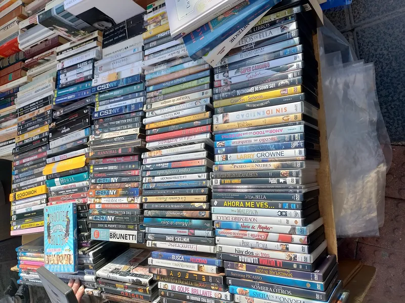 Second-hand DVDs and books at a stall at the El Rastro flea market in Madrid