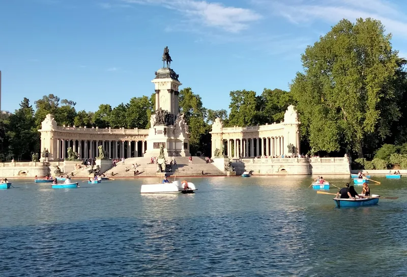 Rowing boats on the Estanque Grande in Madrid's Retiro Park, with the Alfonso XII monument behind
