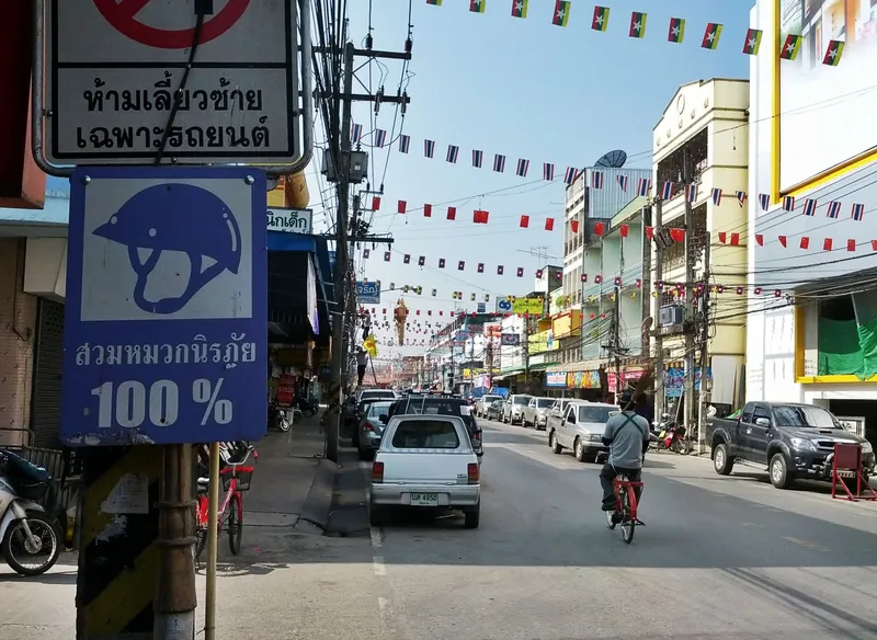 Main street in central Chiang Rai with bunting and traffic