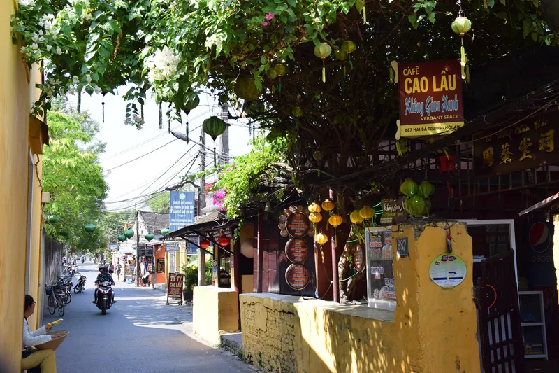 Lane in Hoi An's Old Town with lanterns, bougainvillea and cao lau restaurants on Hai Ba Trung Street